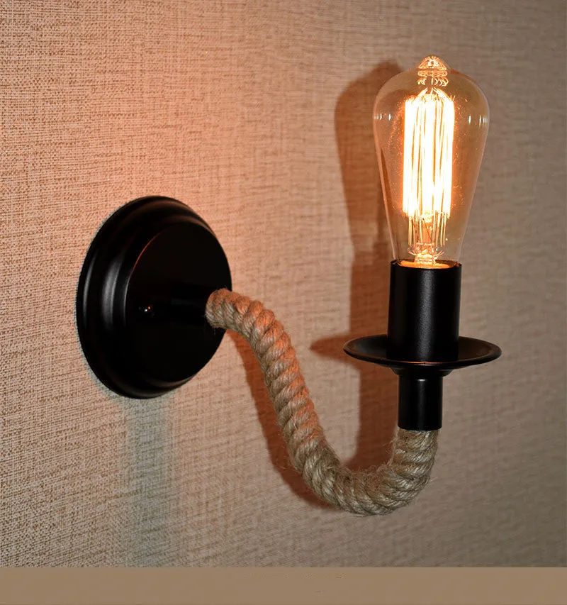 Retro creative wrought iron twine wall lamp in black with handmade hemp rope wrap on a bedside table