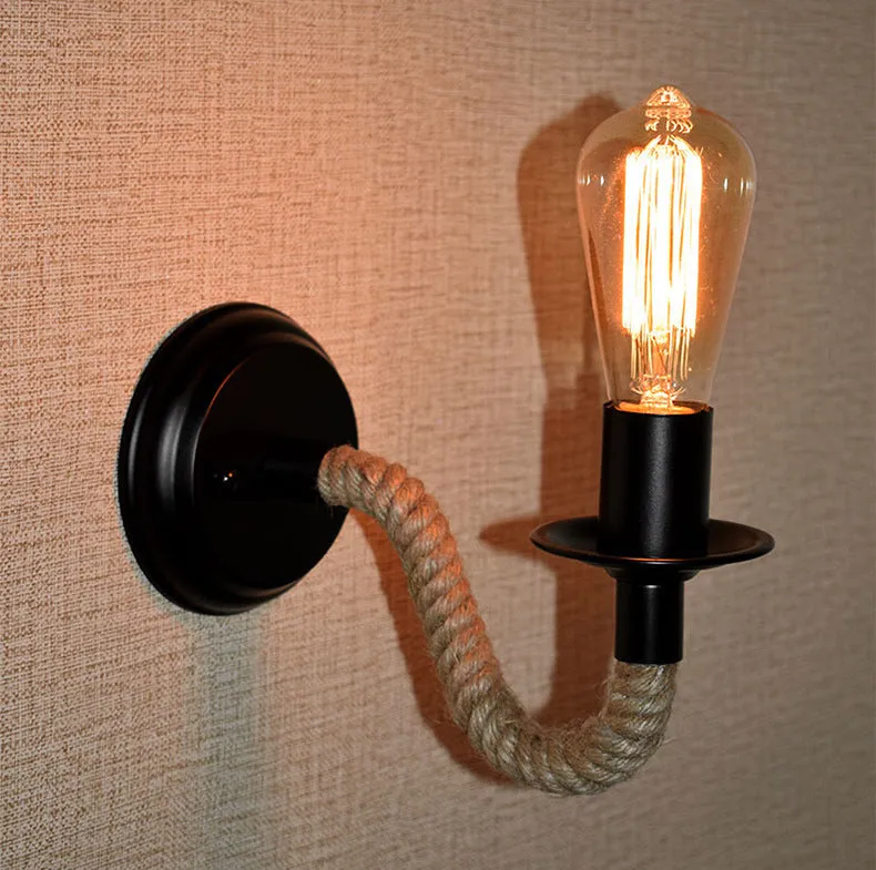 Retro creative wrought iron twine wall lamp in black with handmade hemp rope wrap on a bedside table