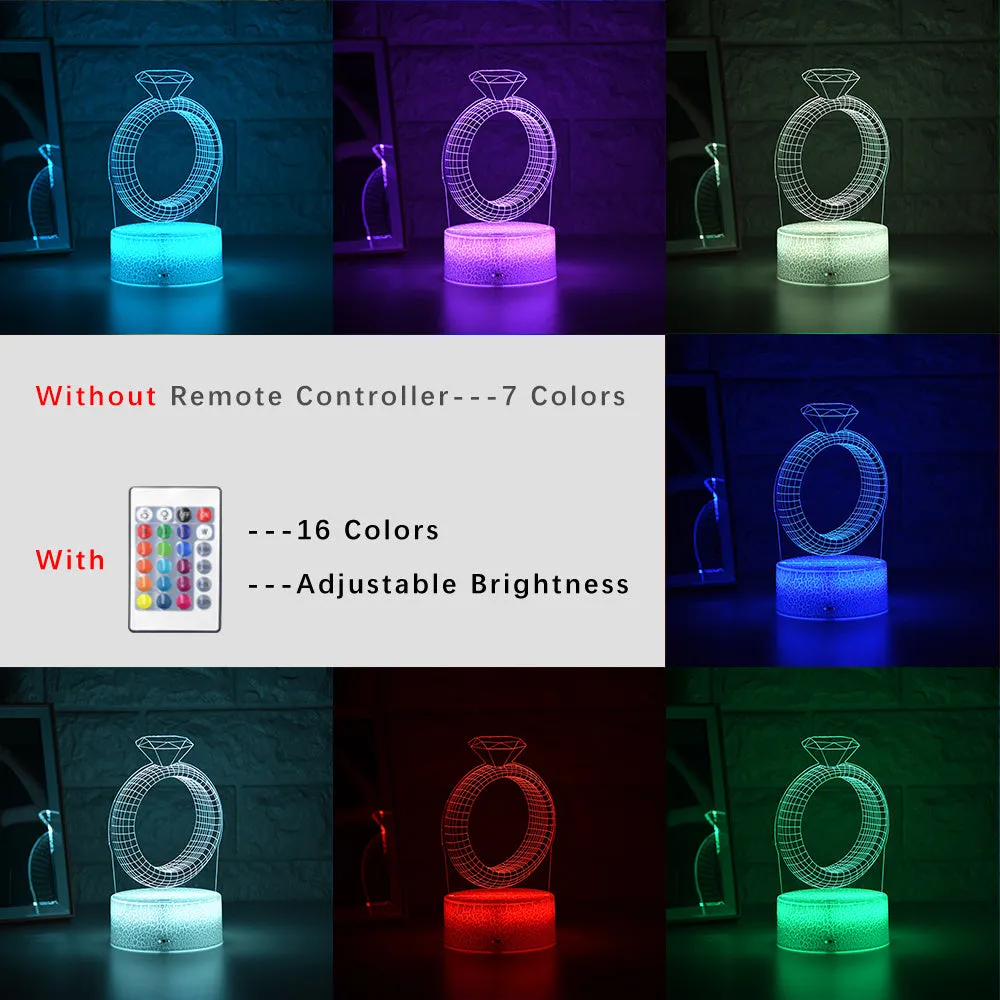 3D holographic diamond ring LED night light with colour changing modes on a bedside table.