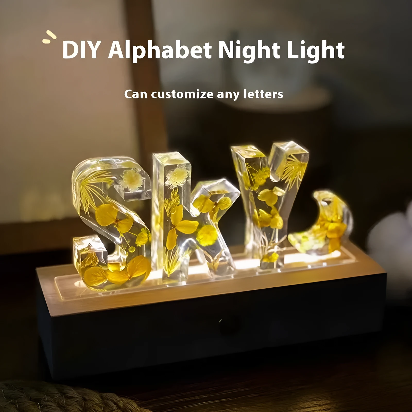 Letter small night lamp with dried flowers, blue colour, warm light, on a table