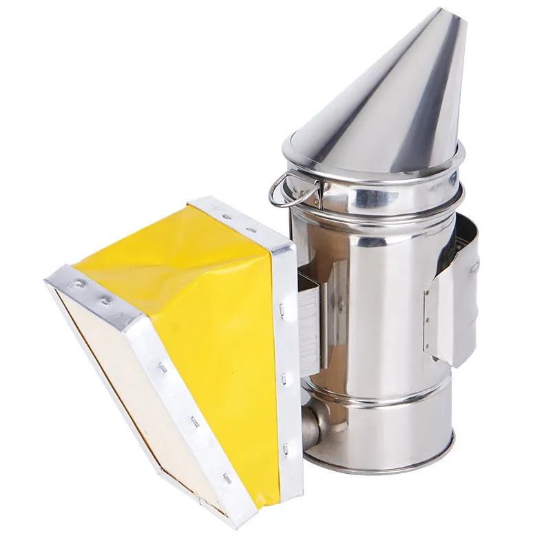 Portable stainless steel beekeeping smoker with leather bellows on a wooden surface