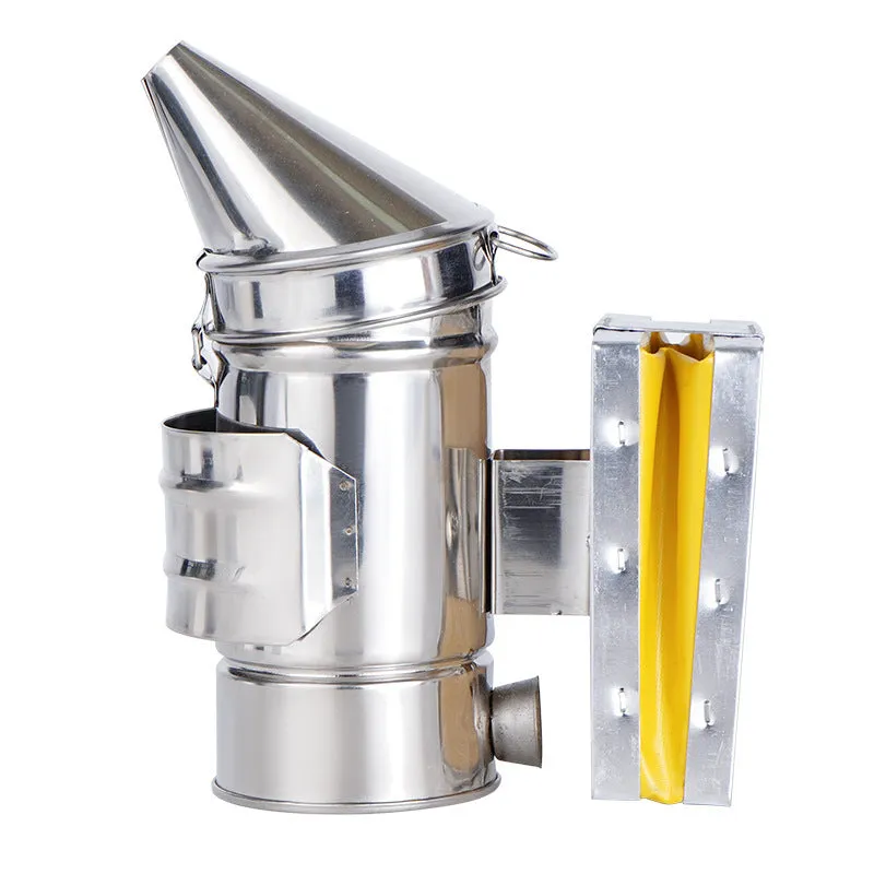 Portable stainless steel beekeeping smoker with leather bellows on a wooden surface