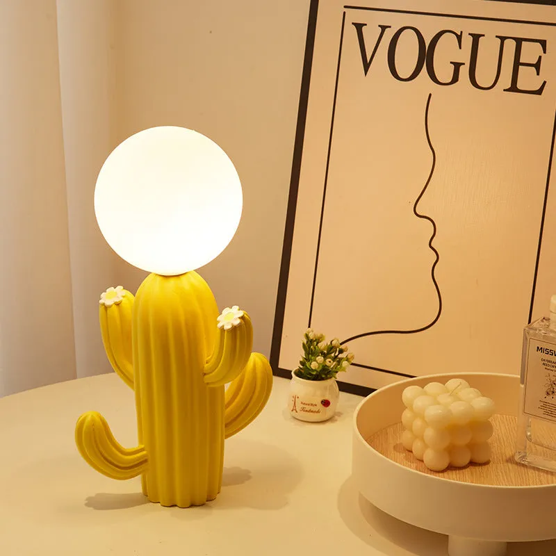 Green cactus button desk lamp with three-colour accents on a bedside table in a child's room