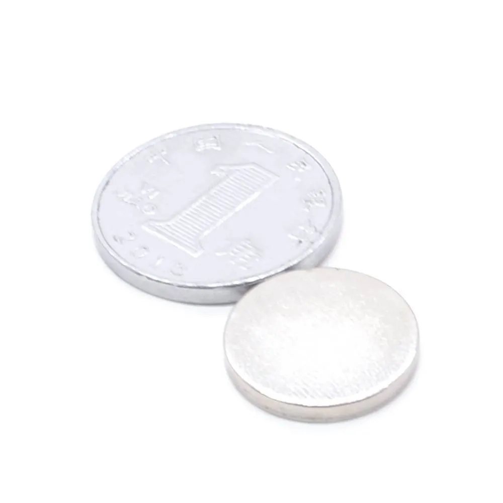 Silver NdFeB disc magnet 14mm diameter 2mm thickness on white background
