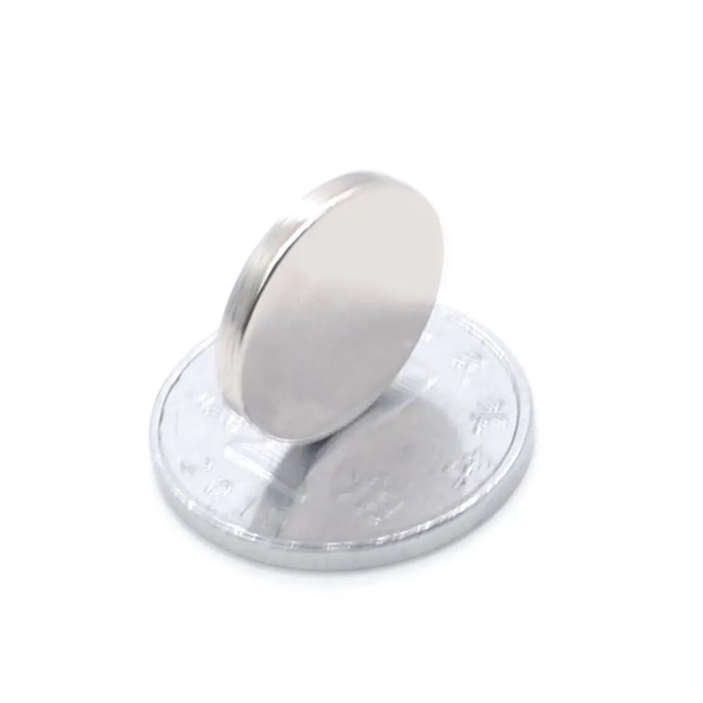 Silver NdFeB disc magnet 14mm diameter 2mm thickness on white background