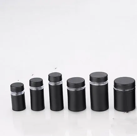 Metal standoff screws in black finish for mounting glass signs on a wall