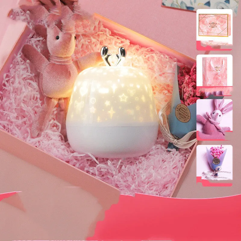 LED starry sky light projector with USB cable and projection film on a tabletop
