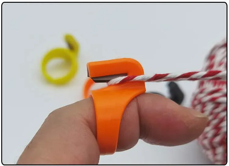 Three seam ripper ring knives in black, orange, and yellow with carbon steel blades and ABS plastic handles