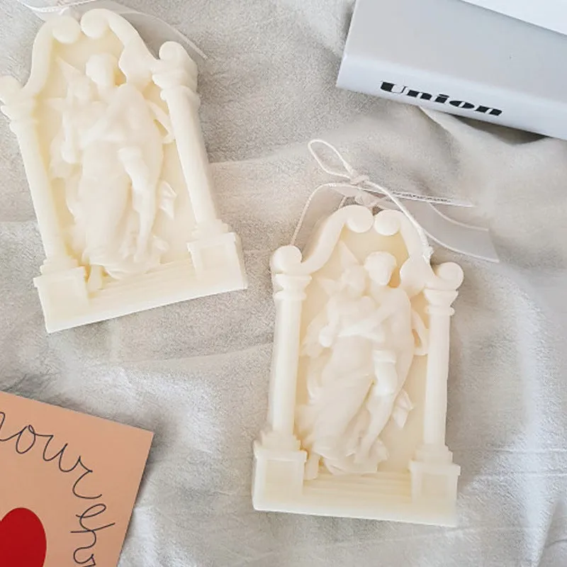 Square elf shaped silicone baking mold for angel aromatherapy candle ornaments and cake decorating on a plain background