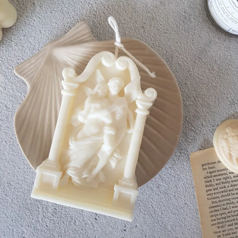 Square elf shaped silicone baking mold for angel aromatherapy candle ornaments and cake decorating on a plain background