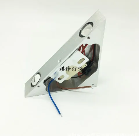Set of three white LED wall lights with dual heads mounted on a wall showing warm white light