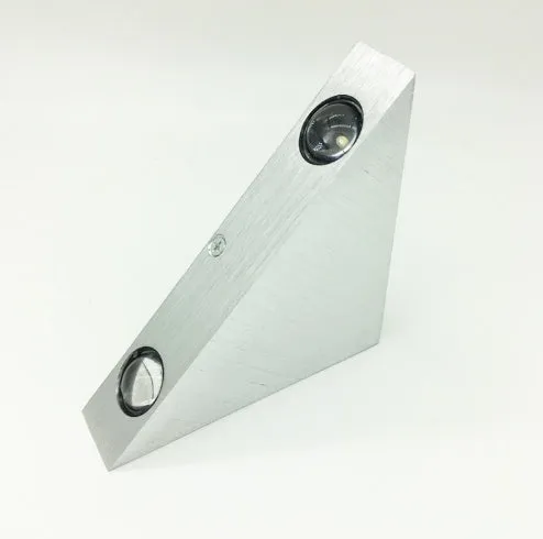 Set of three white LED wall lights with dual heads mounted on a wall showing warm white light