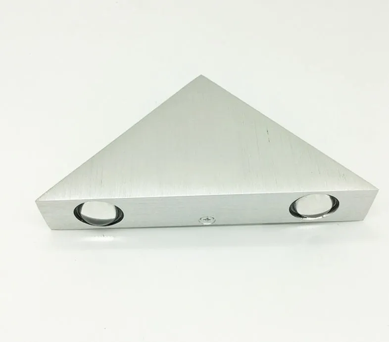 Set of three white LED wall lights with dual heads mounted on a wall showing warm white light
