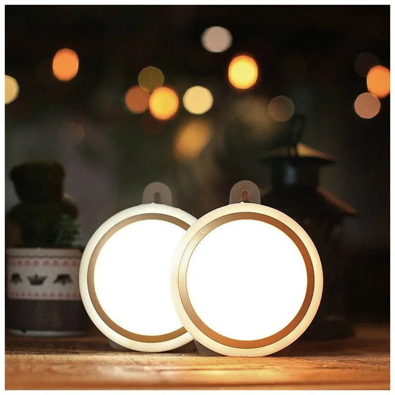 Circular white motion sensor LED light with a compact design, shown mounted on a wall.