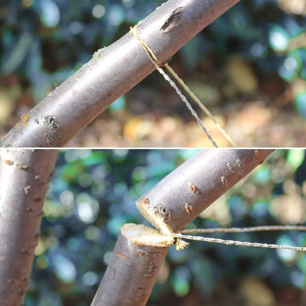 Manual cutting chain saw with handle and wire rope on white background, hand tool for garden pruning