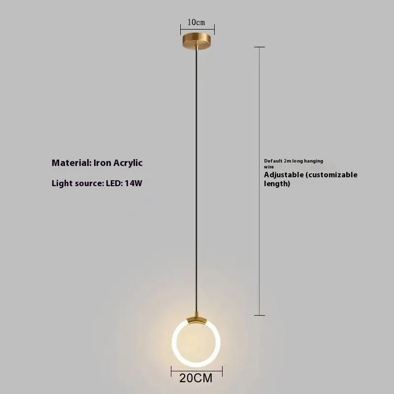Modern Nordic-style U-shaped metal pendant light with a long black cable, hung above a bedside table.