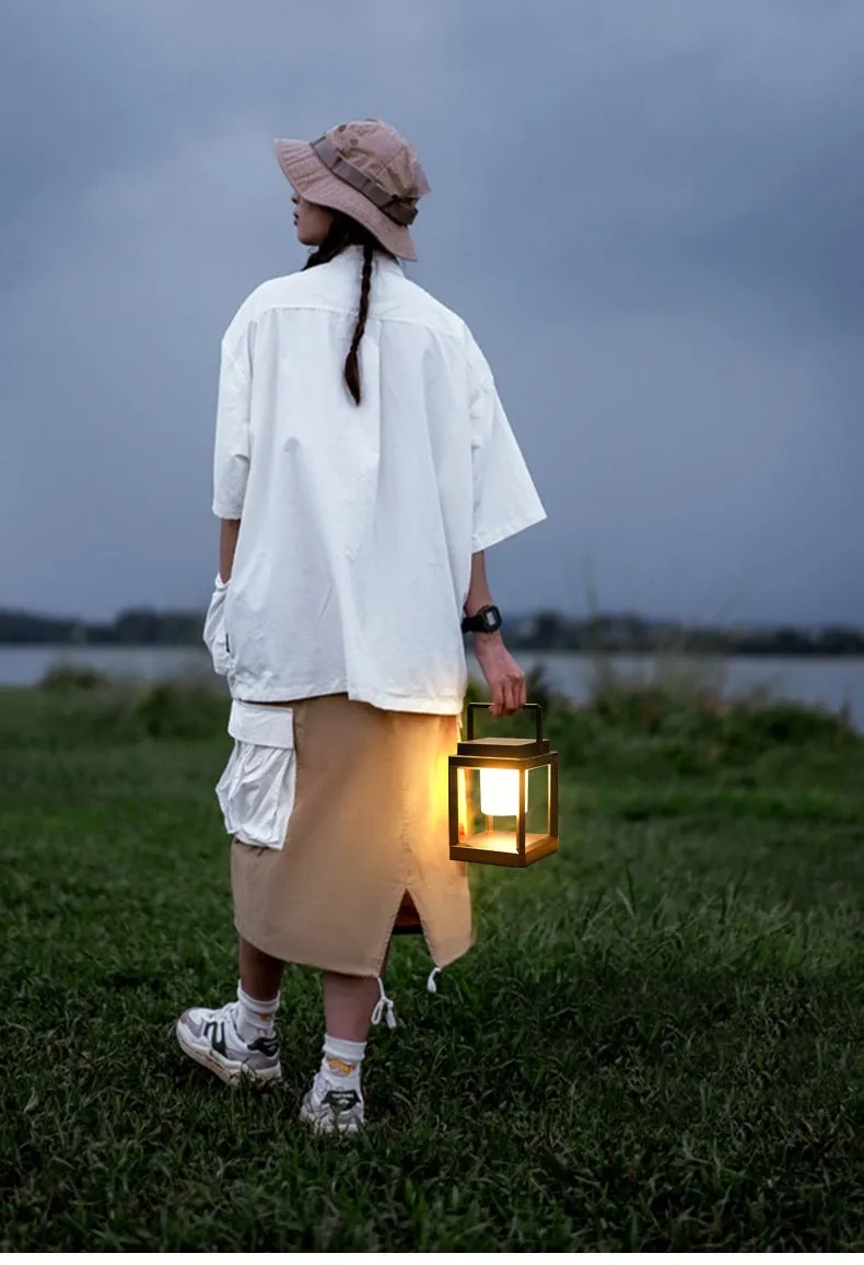 Outdoor USB handheld multifunctional charging ambient light lantern with black cover and white shell