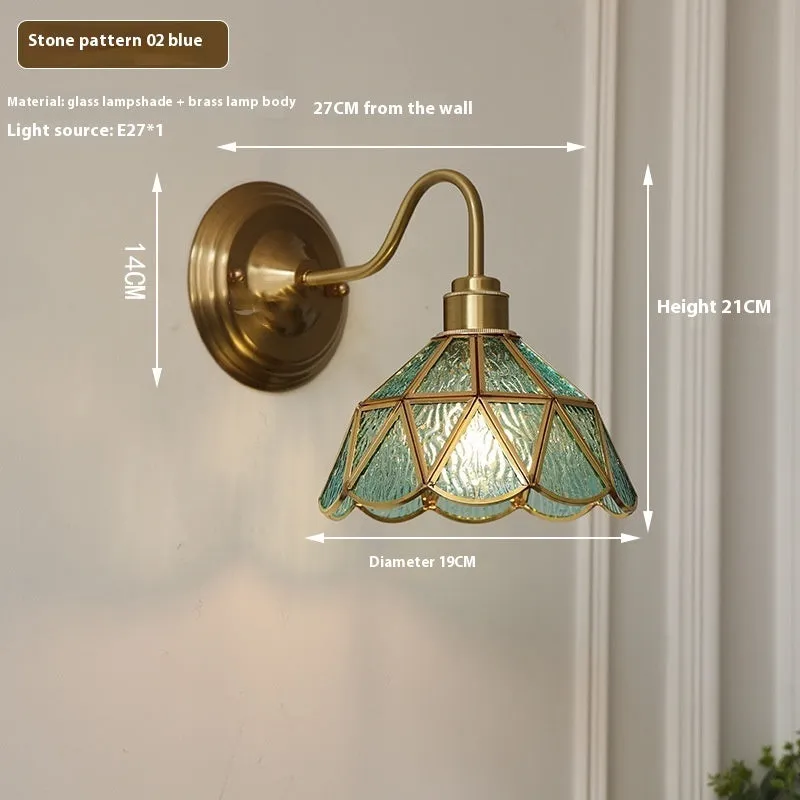 Retro brass glass wall lamp with stone pattern shade in transparent colour, mounted on a wall