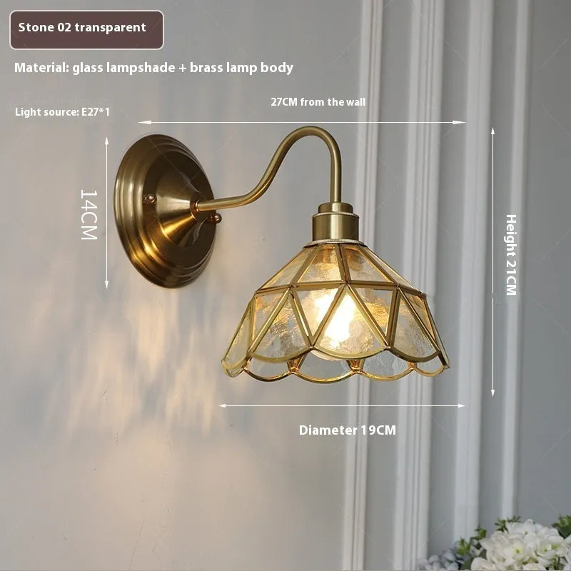 Retro brass glass wall lamp with stone pattern shade in transparent colour, mounted on a wall