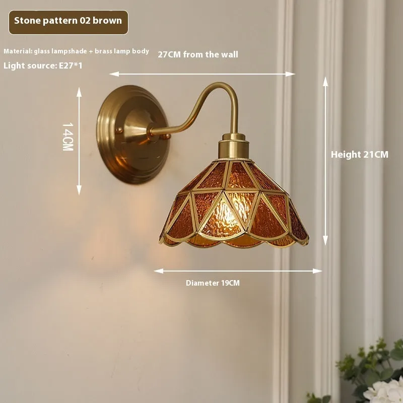 Retro brass glass wall lamp with stone pattern shade in transparent colour, mounted on a wall
