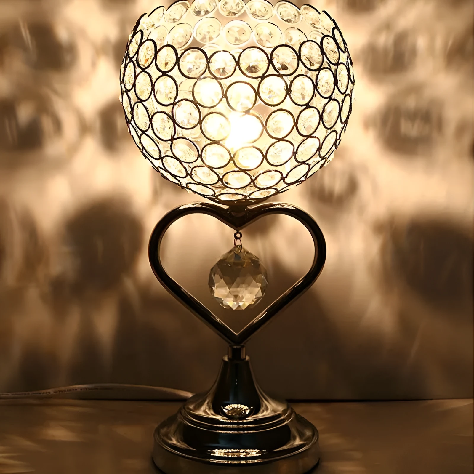 Modern minimalist crystal USB table lamp with heart-shaped design on a bedside table