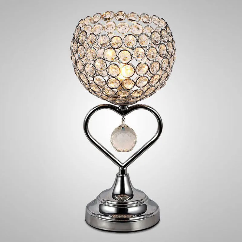 Modern minimalist crystal USB table lamp with heart-shaped design on a bedside table