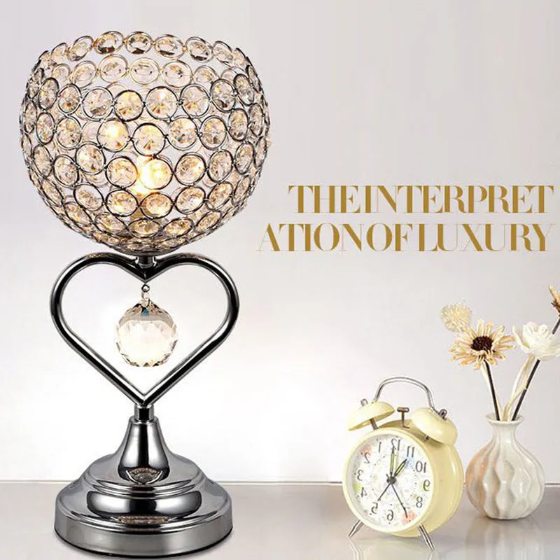 Modern minimalist crystal USB table lamp with heart-shaped design on a bedside table