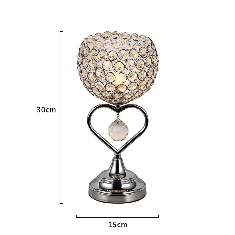 Modern minimalist crystal USB table lamp with heart-shaped design on a bedside table