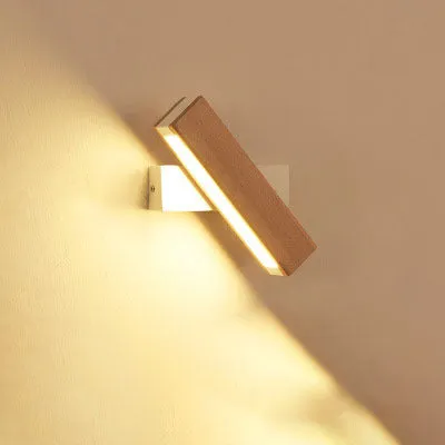 Modern wooden LED wall lamp with adjustable light bar in black finish illuminating room