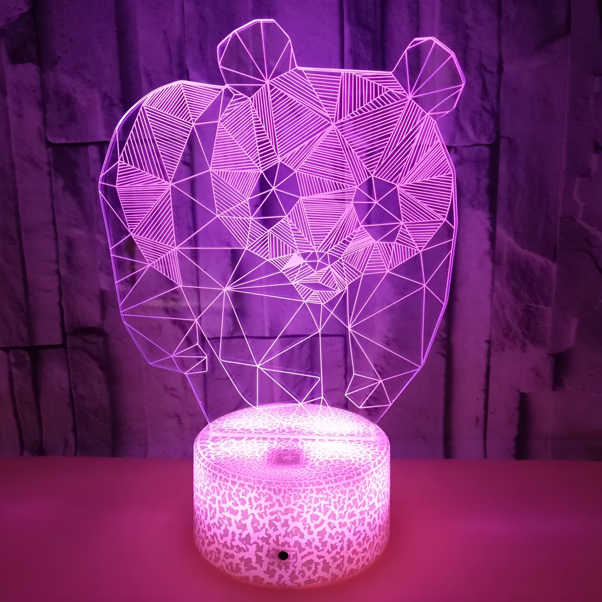 Panda colorful LED 3D night light with remote control showing seven colour gradient on a bedroom shelf