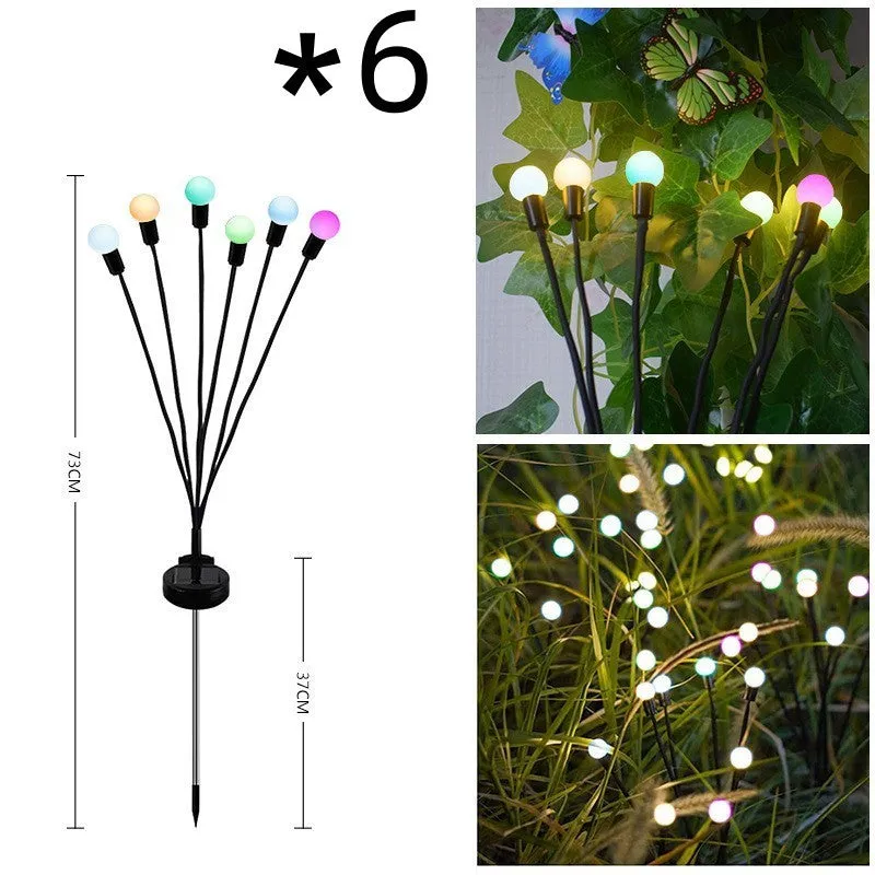 Solar-powered LED firefly garden spike light with multiple heads and a press-in ground plug on grass.