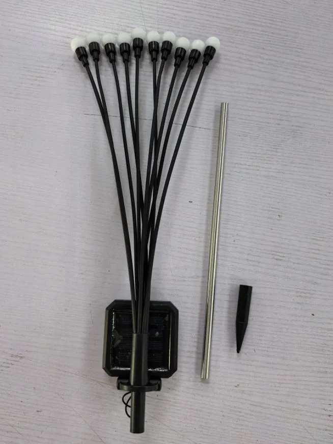 Solar-powered LED firefly garden spike light with multiple heads and a press-in ground plug on grass.