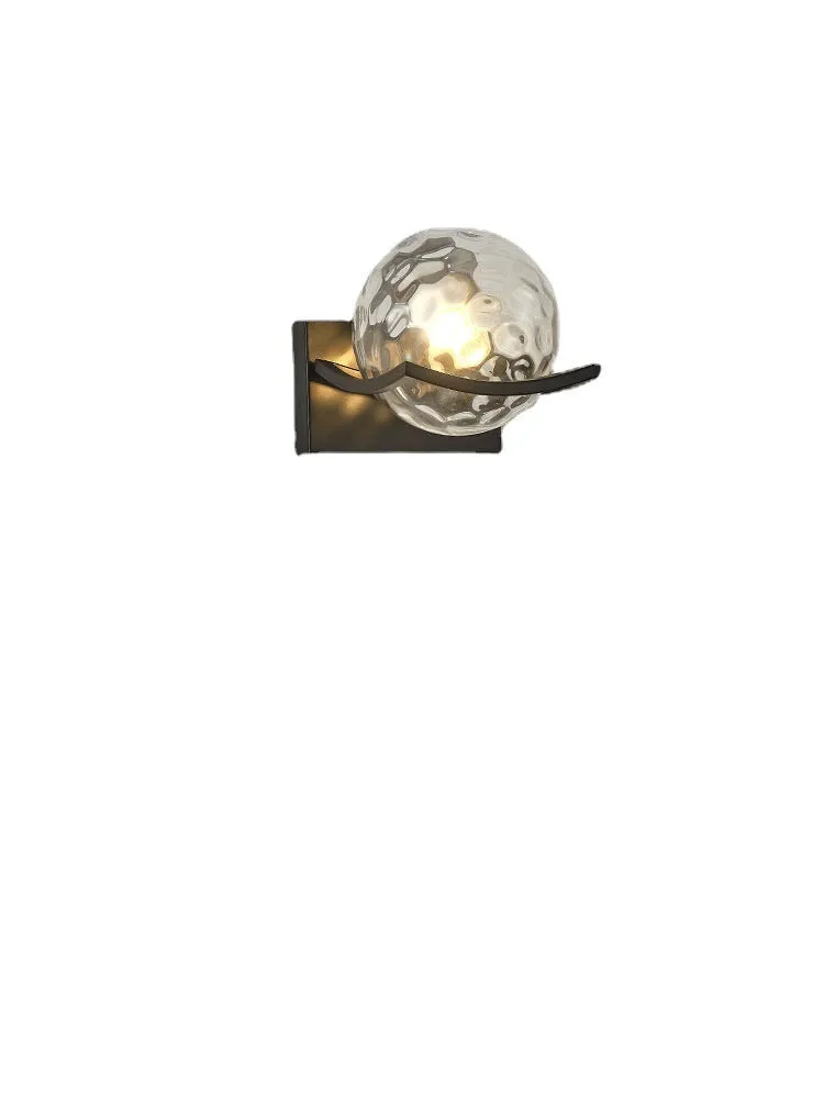 Modern minimalist black wall lamp with striped clear cover mounted beside a bed
