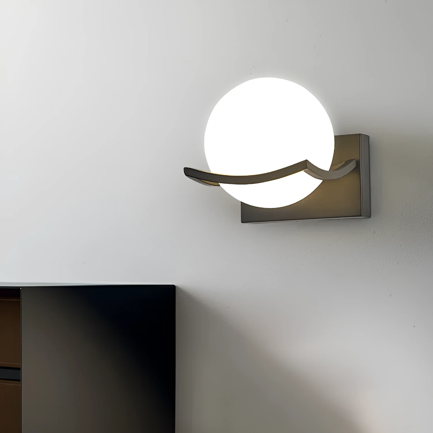 Modern minimalist black wall lamp with striped clear cover mounted beside a bed