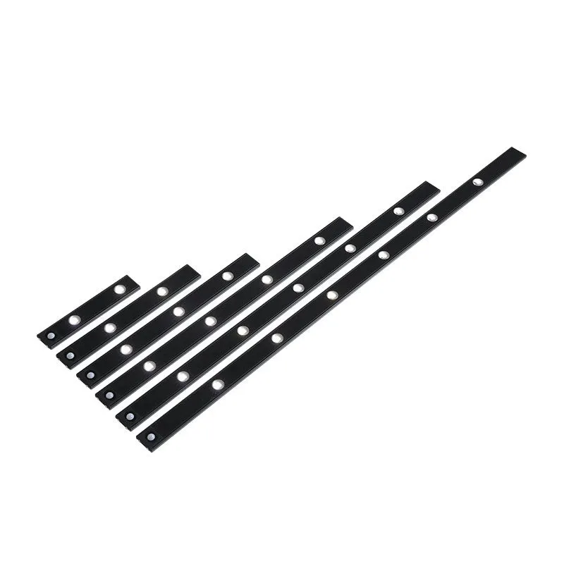 Black geometric cat's eye infrared sensor lamp with three colour light on a cabinet shelf