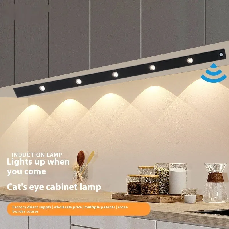 Black geometric cat's eye infrared sensor lamp with three colour light on a cabinet shelf