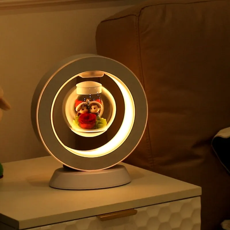 Magnetic levitation lamp with pink eternal rose inside transparent sphere and Bluetooth speaker on USB base