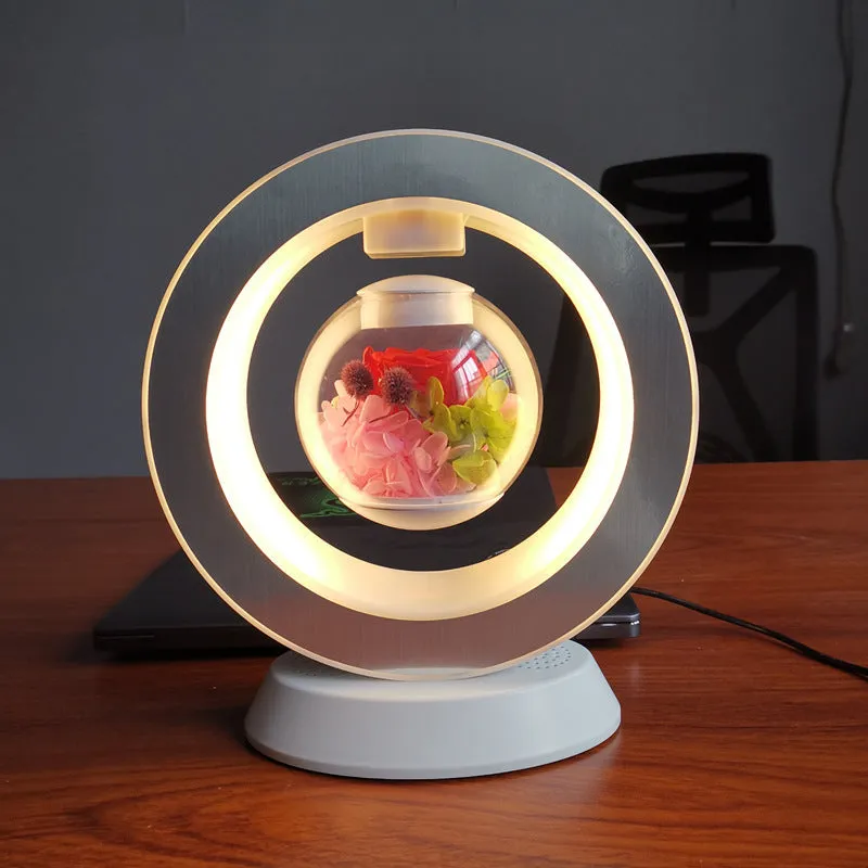 Magnetic levitation lamp with pink eternal rose inside transparent sphere and Bluetooth speaker on USB base