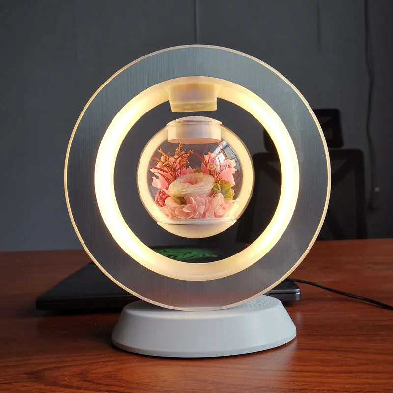Magnetic levitation lamp with pink eternal rose inside transparent sphere and Bluetooth speaker on USB base