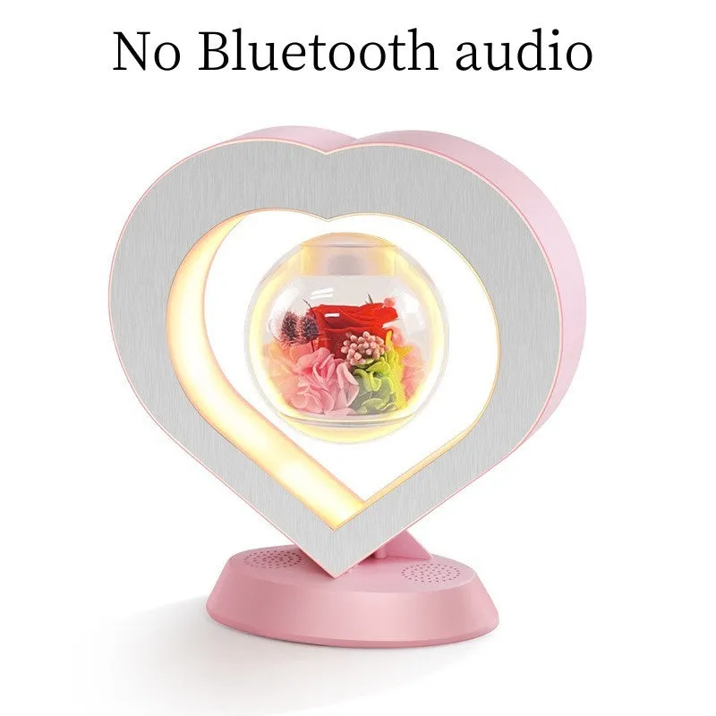Magnetic levitation lamp with pink eternal rose inside transparent sphere and Bluetooth speaker on USB base