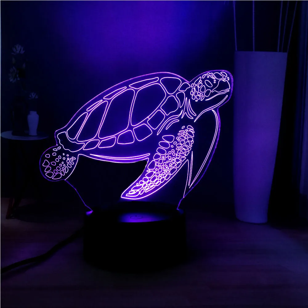 3D acrylic turtle-shaped LED night light glowing in blue, with a remote control.