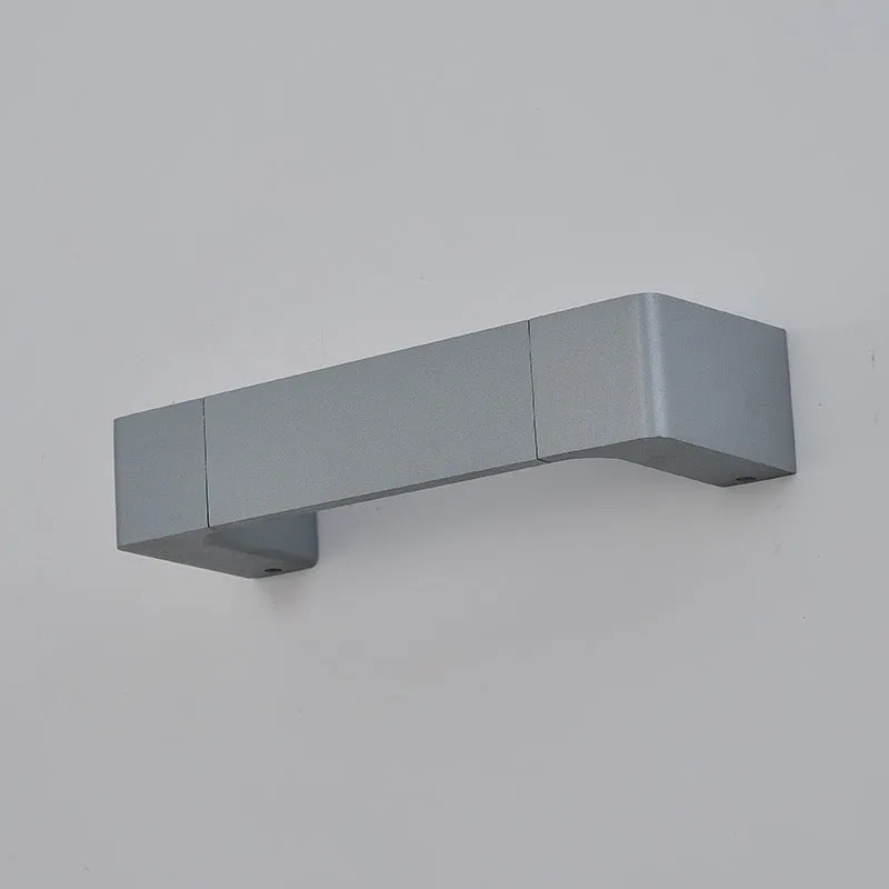 Modern minimalist wall lamp with aluminium shade in gold finish against a white wall