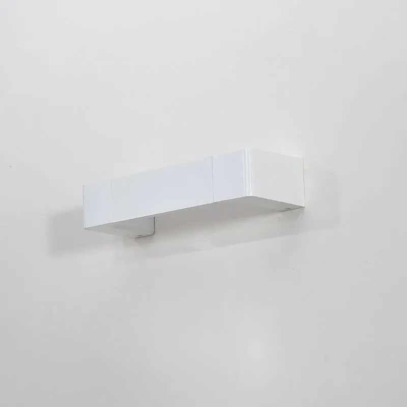 Modern minimalist wall lamp with aluminium shade in gold finish against a white wall