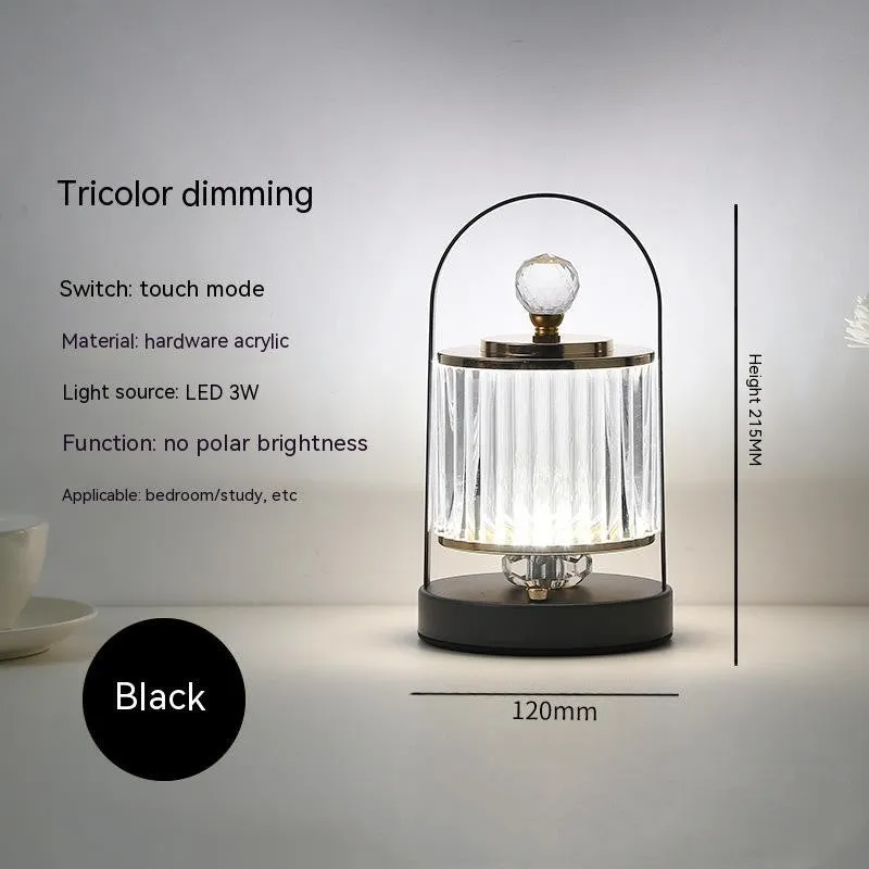 Portable black metal and acrylic LED table lamp with touch dimmer, USB rechargeable, 3W, on a camping table