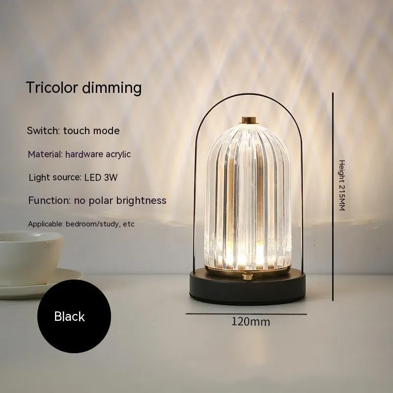 Portable black metal and acrylic LED table lamp with touch dimmer, USB rechargeable, 3W, on a camping table