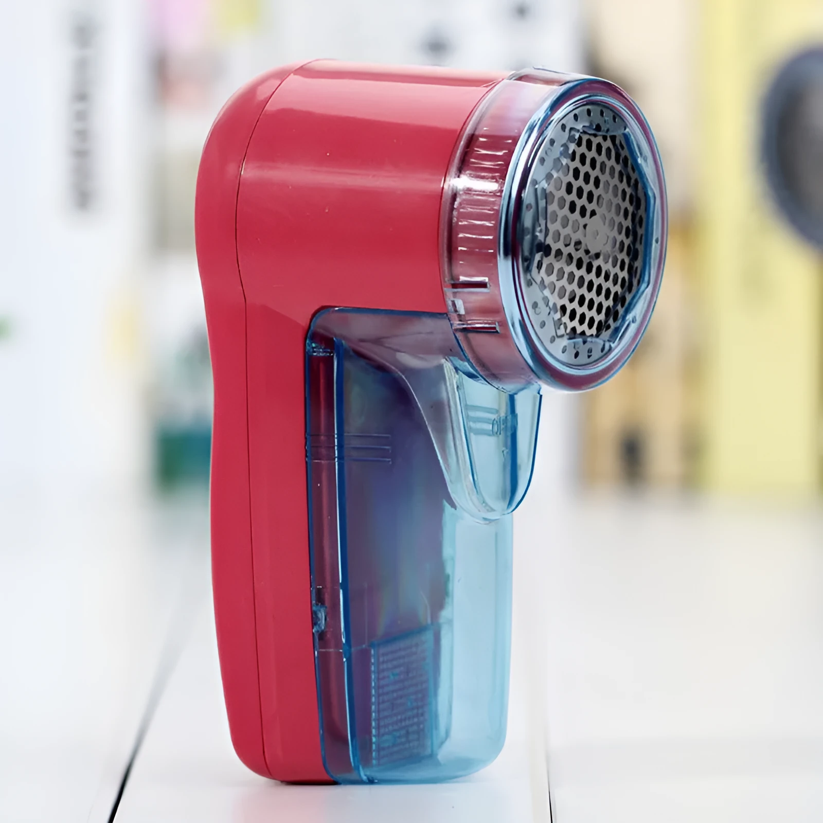 Blue portable electric lint remover for clothing on a white background.
