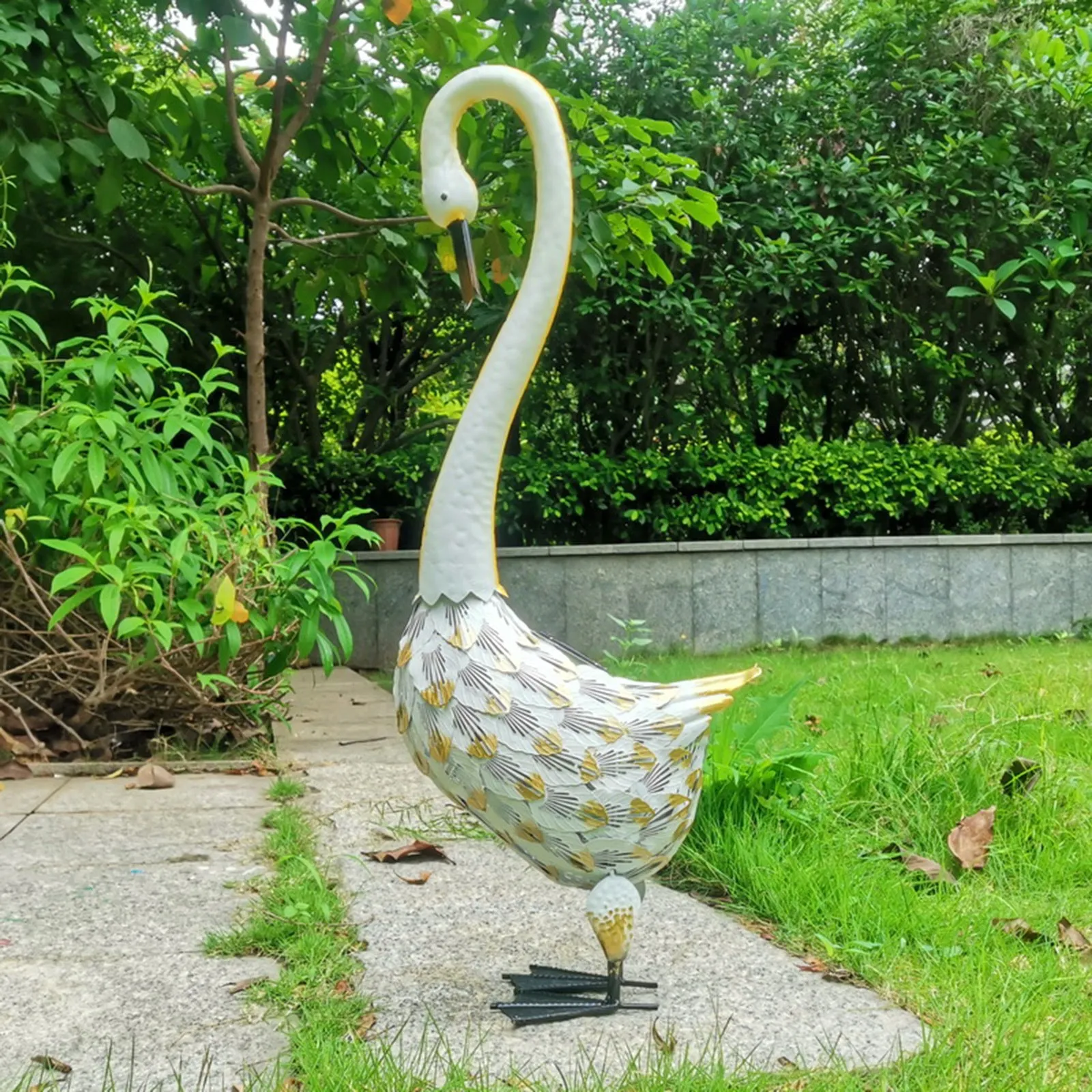 Solar powered duck-shaped wrought iron garden light with warm white LED on lawn