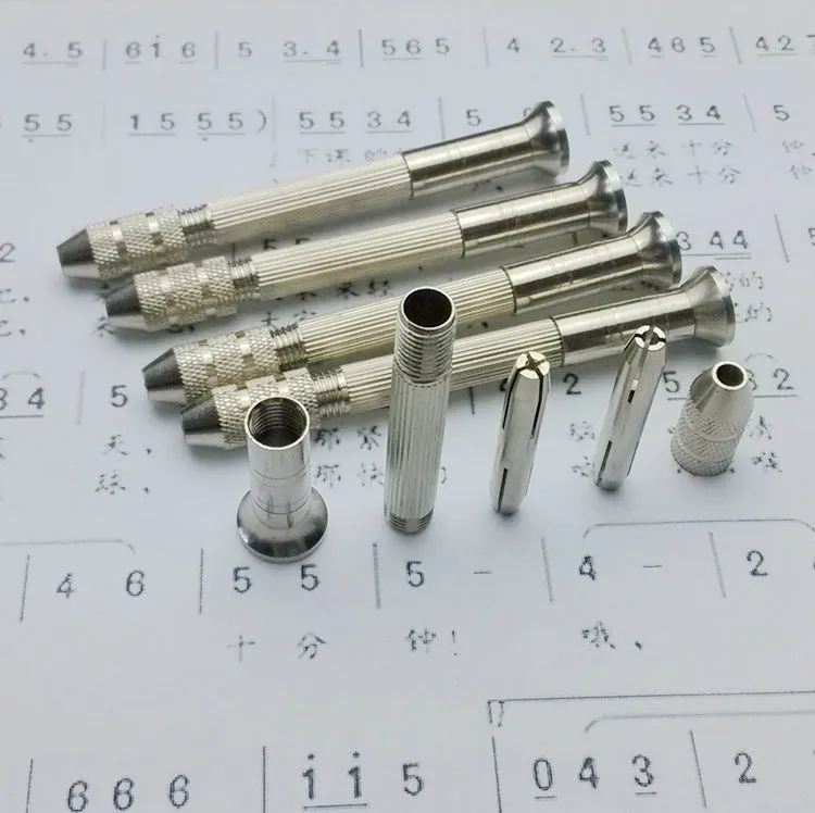 Hand twist drill with two collets and four drill bits on a wooden surface