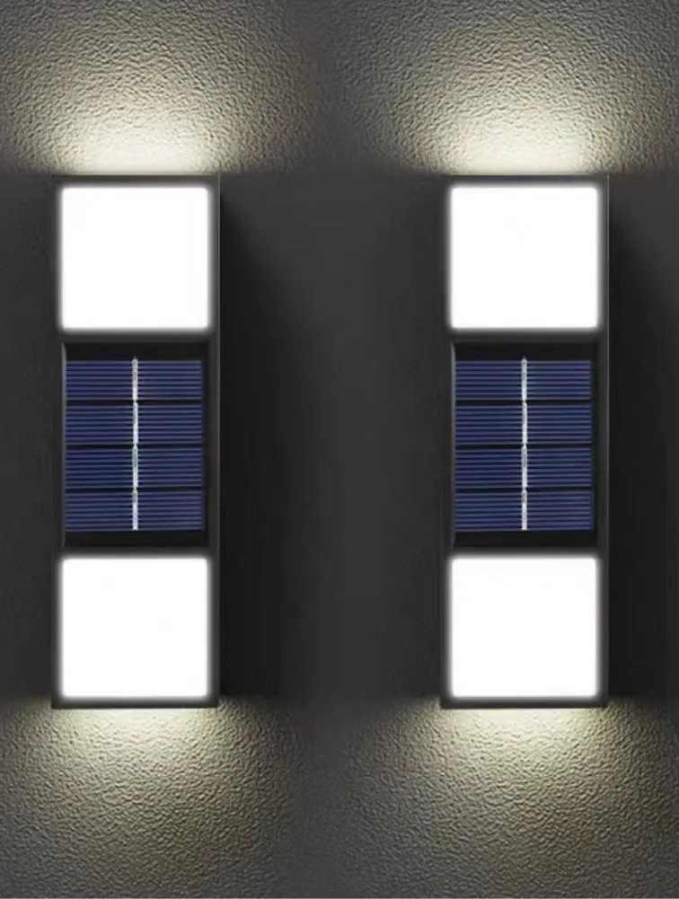 White solar wall lamp with bidirectional sensor mounted on a brick wall, showing warm light illumination