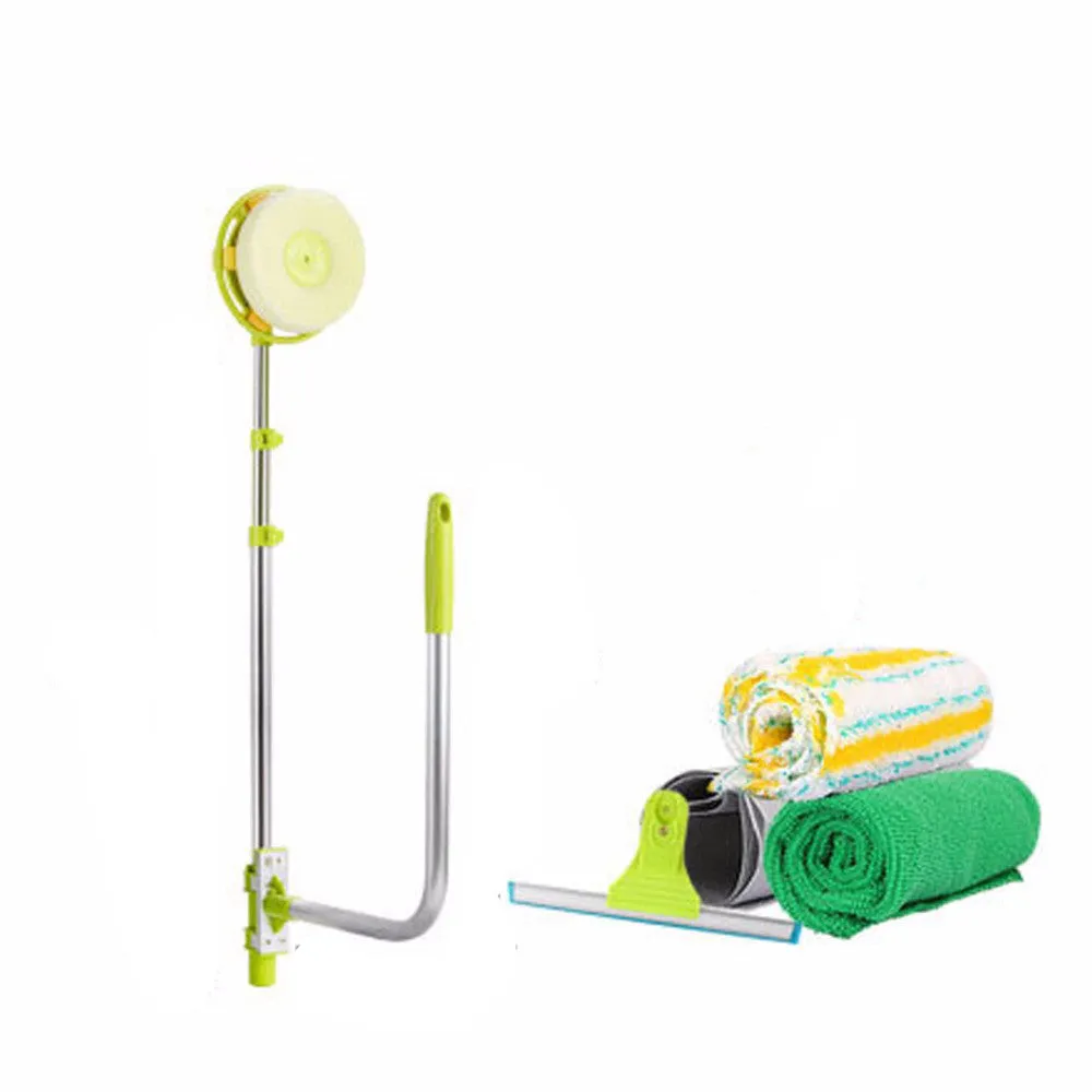 Green telescopic glass wiper with extendable handle resting on a windowsill